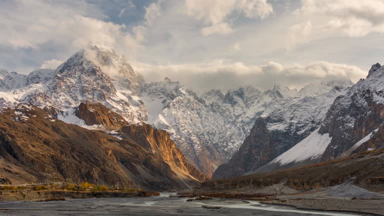 Timelapse Moving Cloud Sunrise Scene of Majestic view of snow capped mountains in Karakoram Range in the autumn in Passu valley, Hunza Valley District in Pakistan