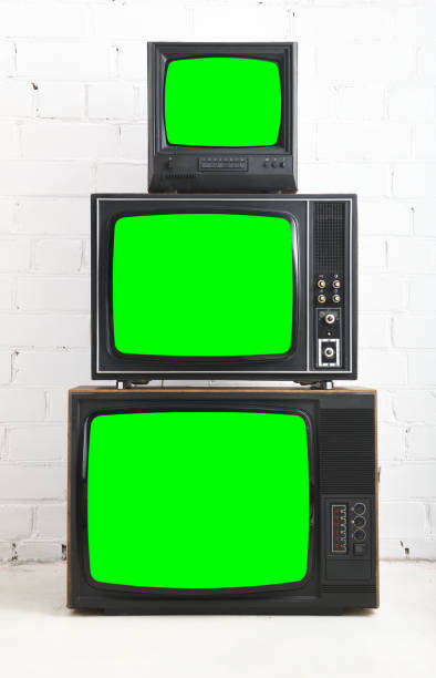 istock Three old televisions with a green screen against a white brick backdrop. 1480228006