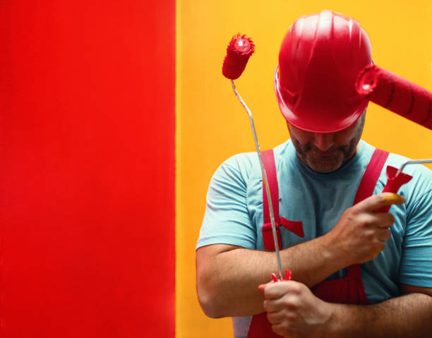 An Asian male painter is creating