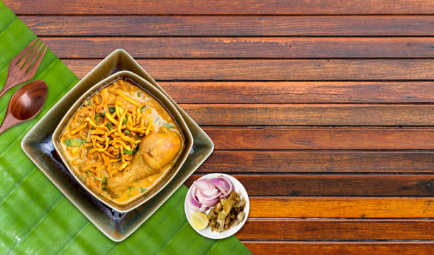 istock Chicken Khao Soi on banana leaf with space on wooden table background 1480228216
