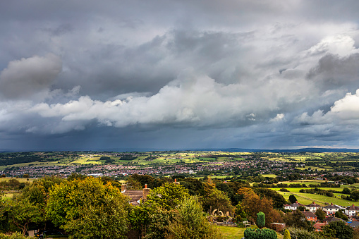 View over houses and fields with dramatic sky