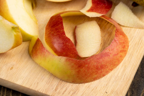 istock Peel and slice ripe red apples, close up 1480236321