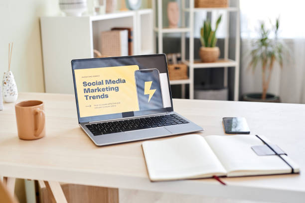 istock Background of home office workplace with SMM trends on laptop screen 1480237425