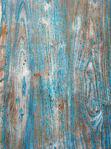 Stock photo showing a close-up elevated view of turquoise blue, textured wood grain background pattern with copy space.