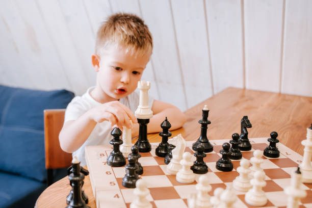 istock Child playing chess at home at the table 1480240604