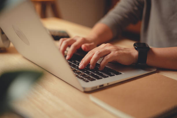 istock Close-up shot of female hands typing on keyboard using laptop at home office. 1480242697