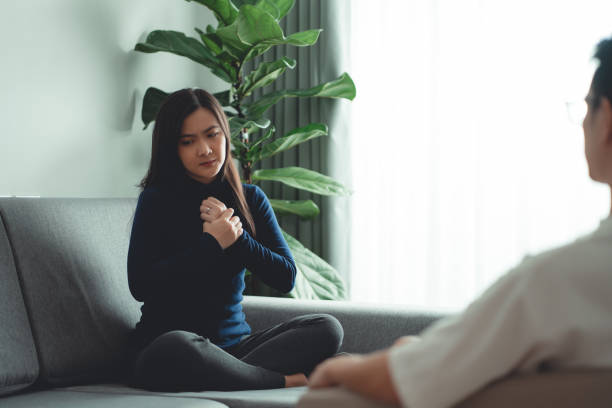 istock Asian woman talking with psychologist about problems after married sitting on sofa in counseling office. 1480242910