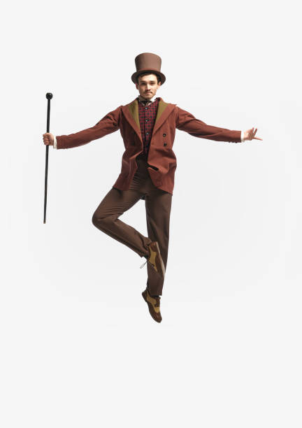 Floating in the air. Shot of levitating man wearing vintage clothes, cylinder black hat and spreading hands to side over. Concept of historical remake, ad, comparison of eras, fashion, retro, vintage