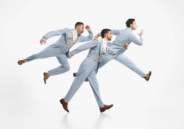 istock Serious men wearing elegant suit hurry up over white background. Going on important business 1480244110
