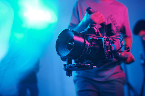 cameraman shooting with professional camera - tripod camera photographic equipment photography imagens e fotografias de stock