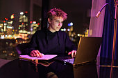 Teenage boy doing homework late at night