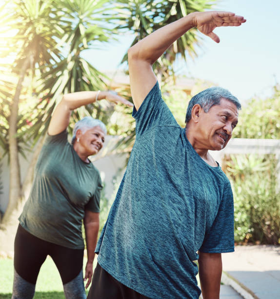 fitness, yoga and health with a senior couple outdoor in their garden for a workout during retirement. exercise, pilates and lifestyle with a mature man and woman training together in their backyard - latin american and hispanic ethnicity senior adult mature adult couple imagens e fotografias de stock