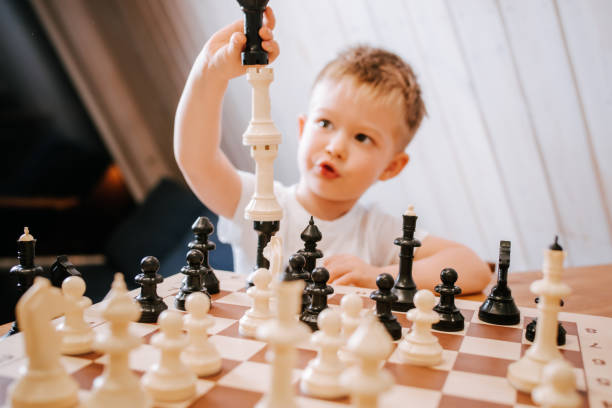 istock Child playing chess at home at the table 1480249382