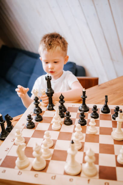 istock Child playing chess at home at the table 1480249505
