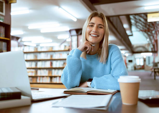 istock Books, portrait or happy woman in a library reading for knowledge or development for future growth. Scholarship, student or school girl smiles with pride studying or learning college information 1480249565