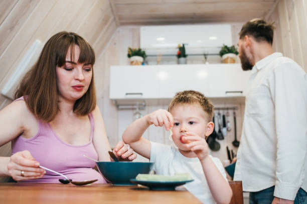 istock Happy family eating pasta in the kitchen 1480249571