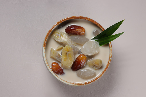 Kolak Pisang Kurma is Banana and Date Compote. Indonesian Dessert Made from Banana and Dates in Coconut milk, Palm Sugar and Pandanus Leaves.