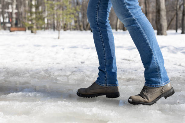 istock woman walking on ice in the park. 1480250761