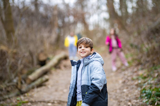 Little boy on a hike with his family posing for the camera