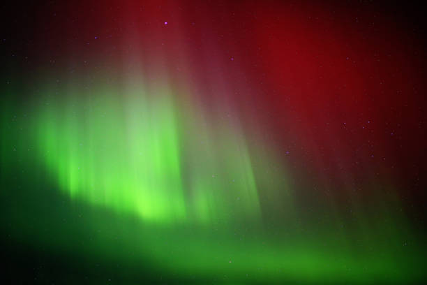 istock Red and green aurora borealis on starry sky 1480261698