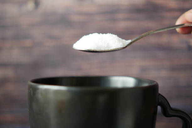 istock pouring white sugar in a coffee cup 1480262613