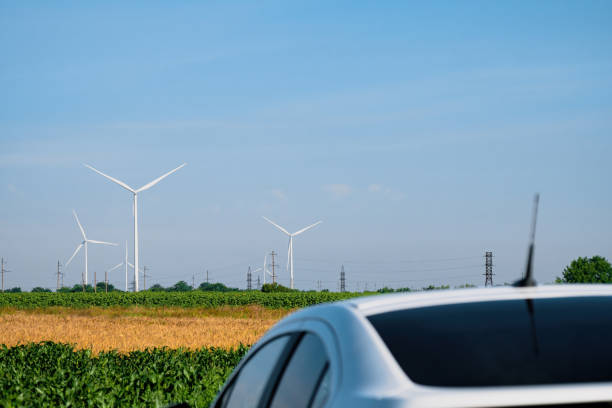 istock Electric car at station against windmills producing energy 1480262905