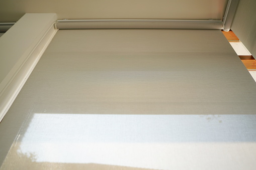 White blind curtain or black blinds Roller sun protection in office.