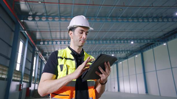 istock Professional caucasian male architect using tablet for work recheck the orderliness or stock of product standing in factory Industrial 1480268909