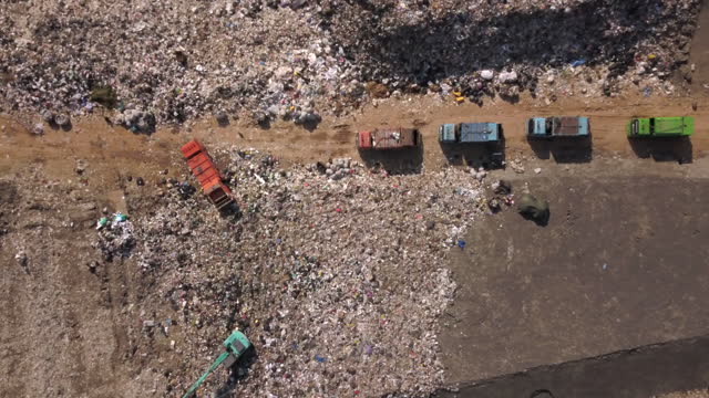 Aerial view landfill with garbage trucks
