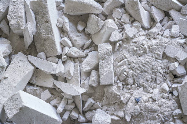 Construction waste debris - remains of white aac - autoclaved aerated concrete brick blocks, closeup detail stock photo