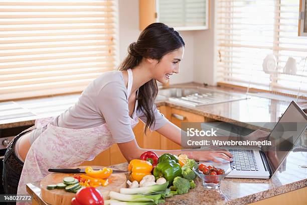 Woman Looking For A Recipe On The Internet Stock Photo - Download Image Now - 25-29 Years, Adult, Adults Only