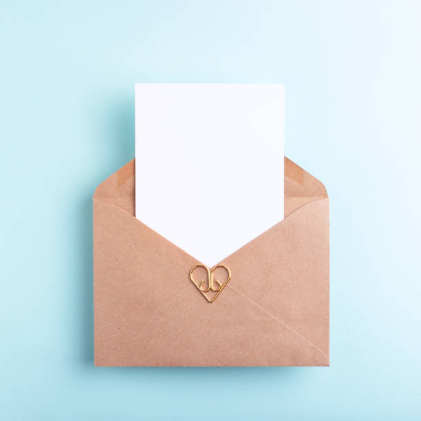istock Top view of empty card in kraft envelope on pastel blue background. 1480273746