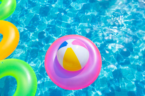 inflatable pool with swimming ring - swimming pool party summer beach ball imagens e fotografias de stock