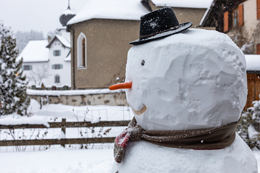 snowman with hat in village