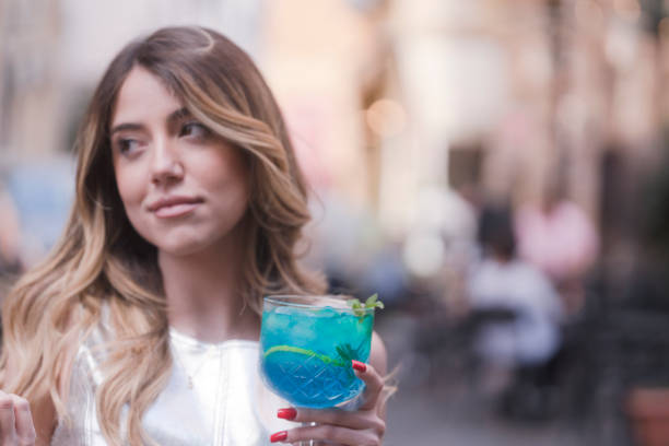 istock Young woman holding a cocktail glass 1480277142