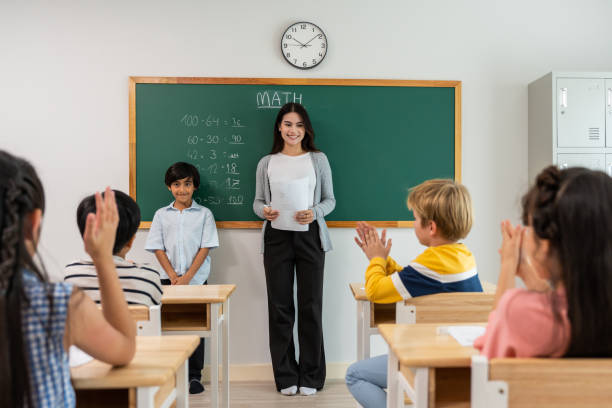 istock Group of student learn with teacher in classroom at elementary school. Attractive beautiful female instructor master explain and educate young children with happiness and fun activity at kindergarten. 1480277255