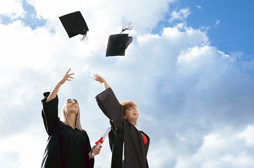 Student with congratulations, graduates wearing a graduation gown of university, white isolated background