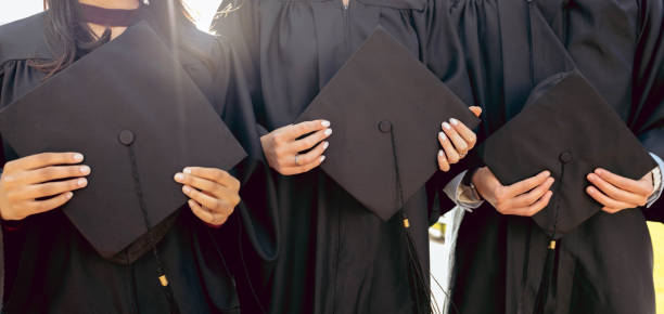 istock University student group, hands and holding graduation cap together in queue, cropped and success for study goal. Friends, students and graduate celebration for education, learning and future career 1480277364