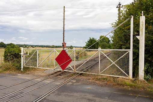 Tenterden, Kent, united kingdom, 21, August, 2022 vintage level crossing barriers across the road to allow train to safely pass