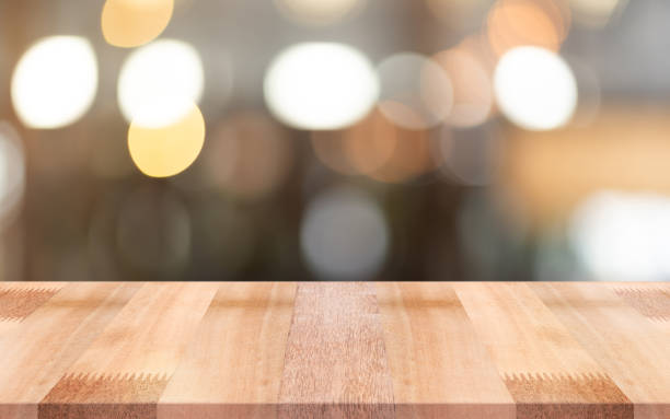 istock Empty wooden table top with lights bokeh on blur restaurant background. 1480277650