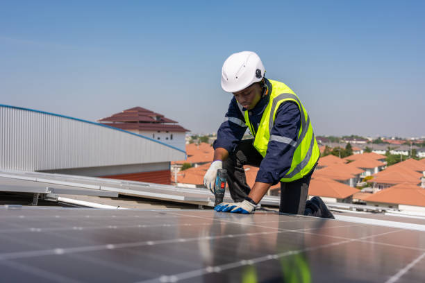 istock Professional engineer work to maintenance of photovoltaic panel system. Attractive technician worker working on roof inspect and check solar cell panels equipment box at solar cell field during sunset 1480277700