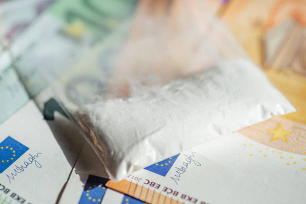 Plastic bag with drugs on Euro banknotes stock photo