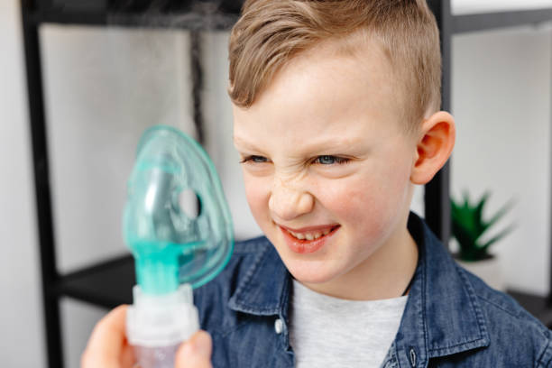 istock Cute boy shows displeasure emotion before inhaling 1480281224