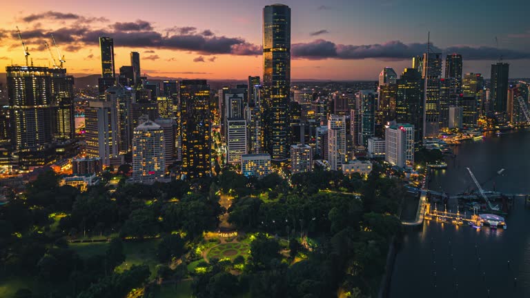 4K Aerial view Day to night Hyper lapse Footage of above Captain Cook Bridge with Brisbane river though Modern office building and Story bridge, Brisbane