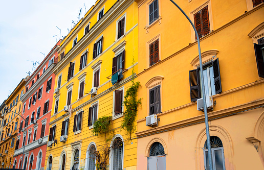 Red facade of traditional tenement house in Madrid, Spain