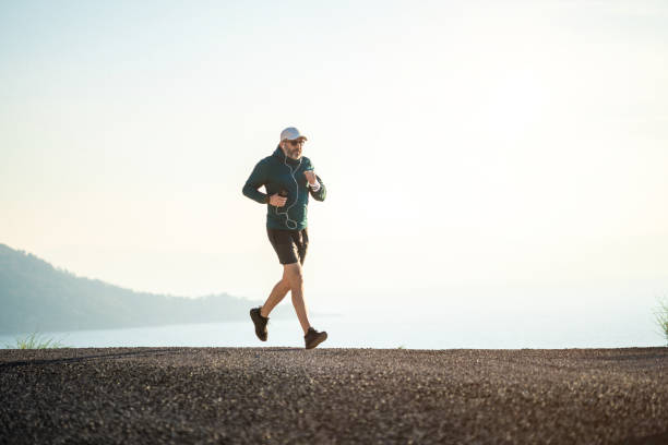 istock Cheerful man jogging in mountains at sunset 1480284415