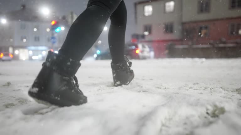 Woman crossing the road in a blizzard