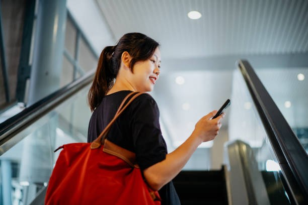 istock Asian Chinese woman using smartphone in subway station 1480284523