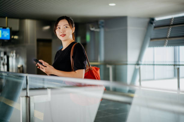 istock Pregnant Asian Chinese woman using smartphone subway station 1480284549