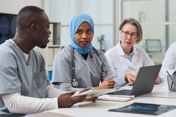 istock Female doctor showing x-ray image on laptop 1480285878